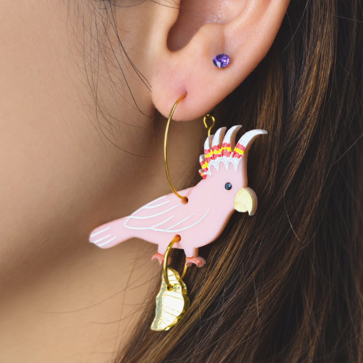 Another view of Major Mitchell's cockatoo with croissant gold hoop earrings