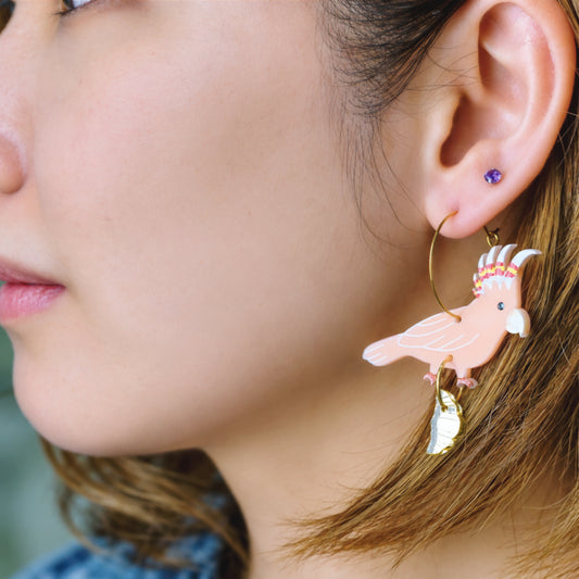 Another view of Major Mitchell's cockatoo with croissant gold hoop earrings