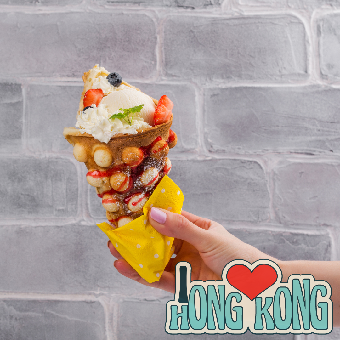 Delicious street food in Hong Kong - egg waffles, fish balls, pineapple buns, curry fish balls, and bubble tea.