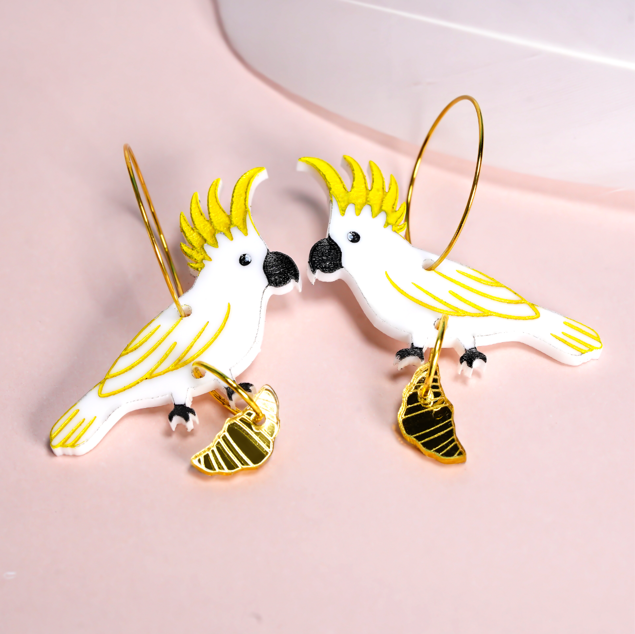 Sulphur crested cockatoo with croissant gold hoop earrings