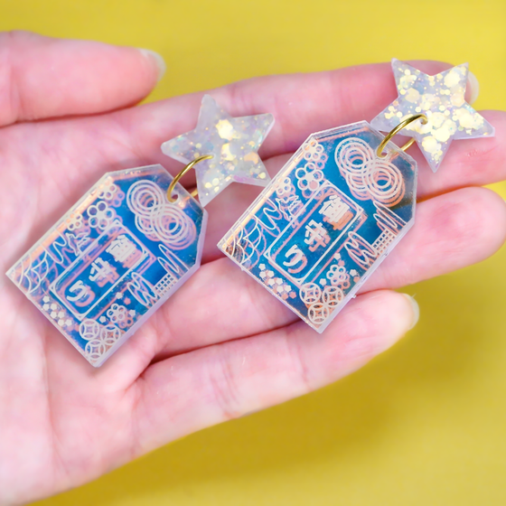 Handmade Hoshi no Omamori earrings inspired by Japanese good luck charms, made from iridescent acrylic and glitter resin in Melbourne
