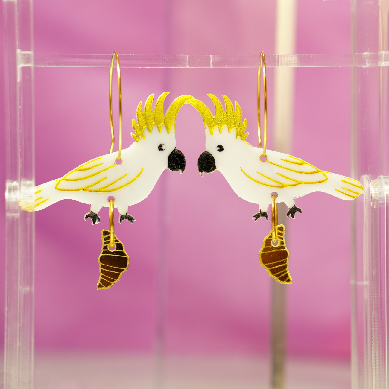 Sulphur crested cockatoo with croissant gold hoop earrings