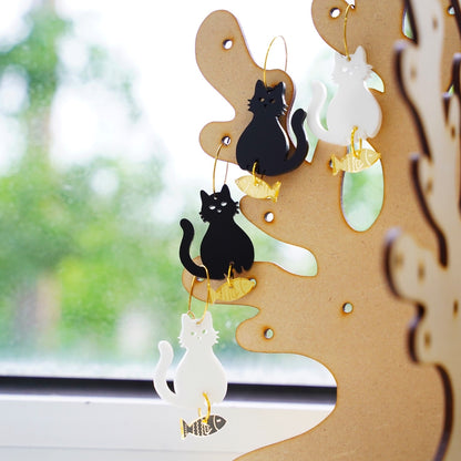 Kuppi and Bear Cat earrings on the earrings stand