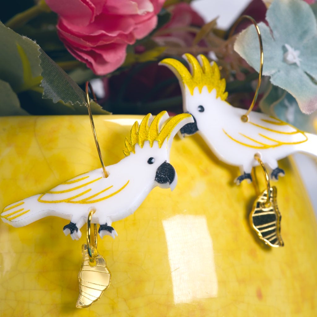 Sulphur crested cockatoo with croissant gold hoop earrings