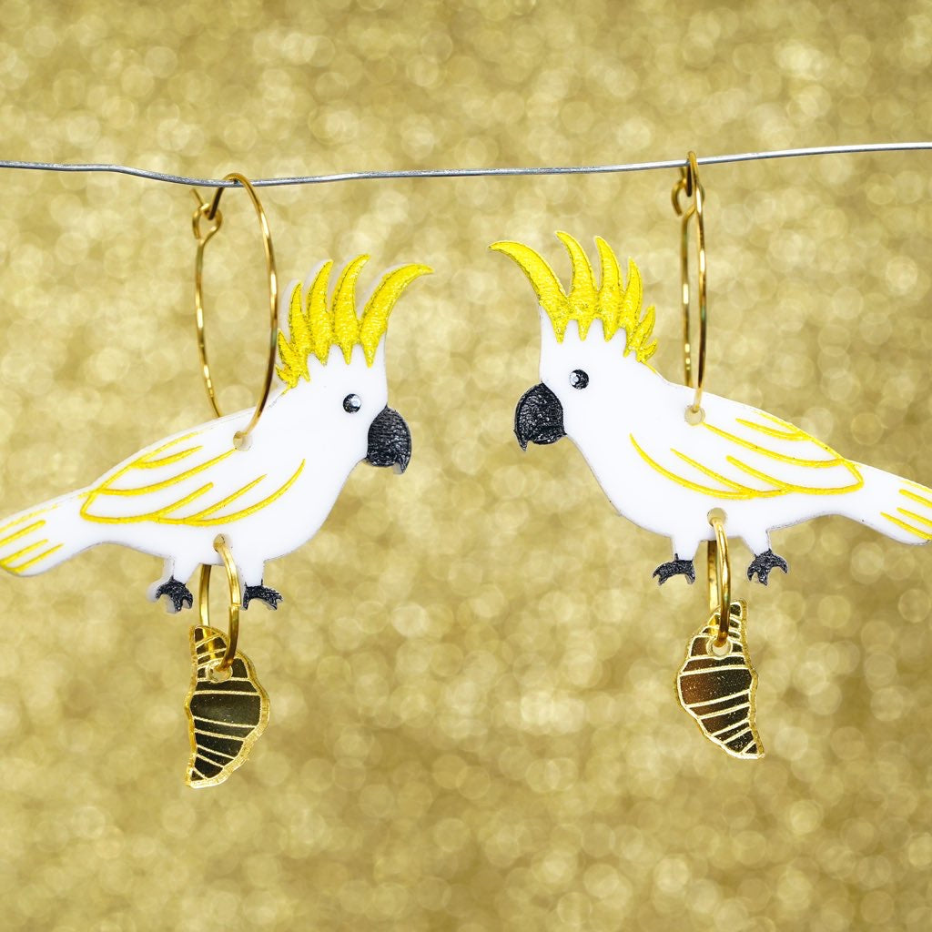 Sulphur crested cockatoo with croissant gold hoop earrings