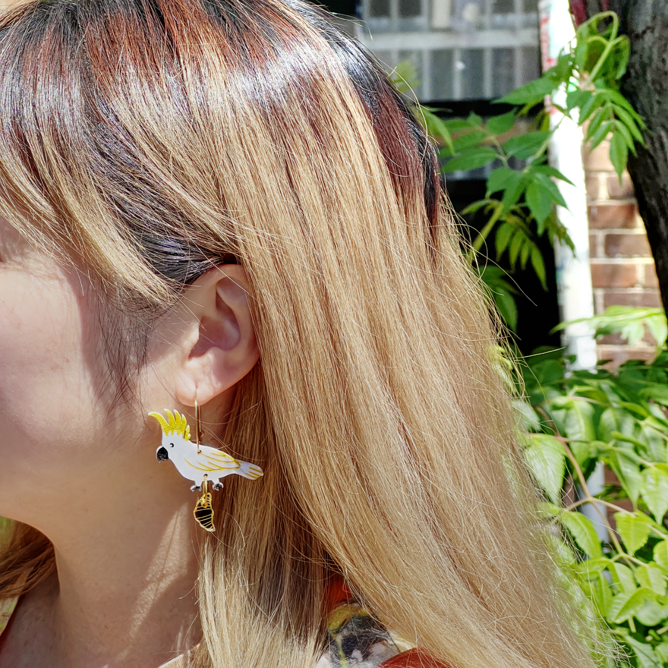 Sulphur crested cockatoo with croissant gold hoop earrings