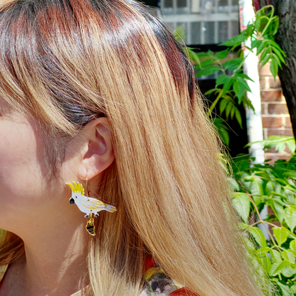 Sulphur crested cockatoo with croissant gold hoop earrings