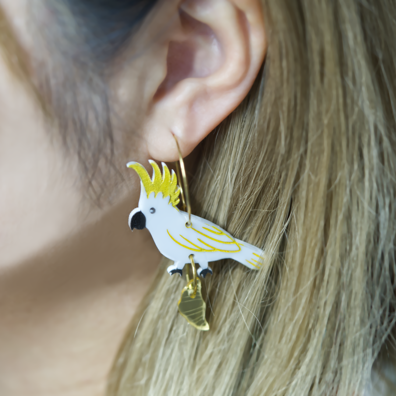 Sulphur crested cockatoo with croissant gold hoop earrings