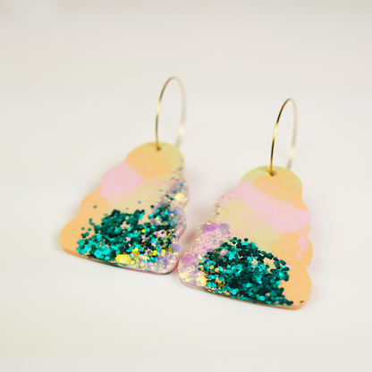 Handmade Wavy Bella earrings featuring colourful hand-poured resin in green, pink, orange and purple tones, with gold stainless steel hoops
