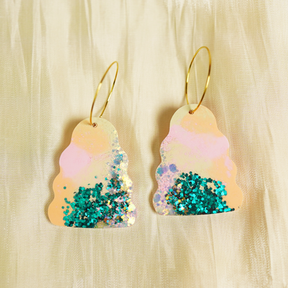 Handmade Wavy Bella earrings featuring colourful hand-poured resin in green, pink, orange and purple tones, with gold stainless steel hoops
