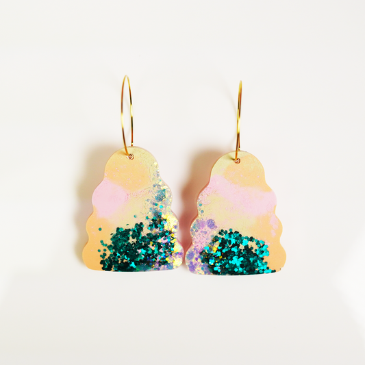 Handmade Wavy Bella earrings featuring colourful hand-poured resin in green, pink, orange and purple tones, with gold stainless steel hoops

