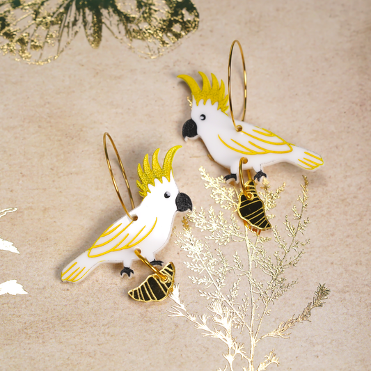 Sulphur crested cockatoo with croissant gold hoop earrings