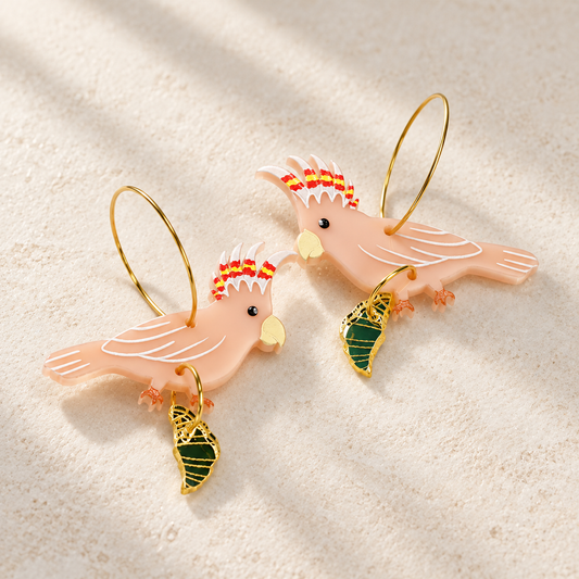 Another view of Major Mitchell's cockatoo with croissant gold hoop earrings